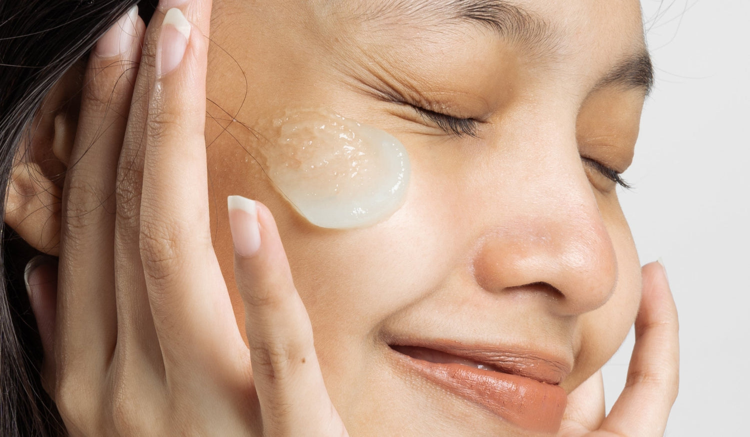 A lady applying a face gel to her face